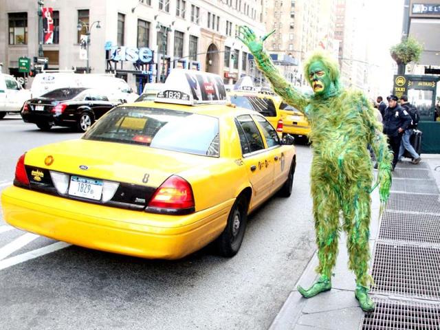 Jeff McCarthy hails a cab dressed as The Grinch outside Madison Square Garden, where "Dr. Seuss' How The Grinch Stole Christmas! The Musical" is playing this Christmas season. AP photo