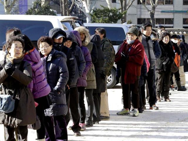 South Koreans wait in line to cast their votes for presidential election at a polling station in Seoul, South Korea. AP photo