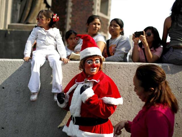 A clown dressed as Santa Claus talks to a woman before a mass at the Basilica of Our Lady of Guadalupe during their annual pilgrimage in Mexico City. As members of the Clown Club of Mexico, the clowns have been making the pilgrimage for over 30 years to pay their respects to the Virgin of Guadalupe. (Reuters)