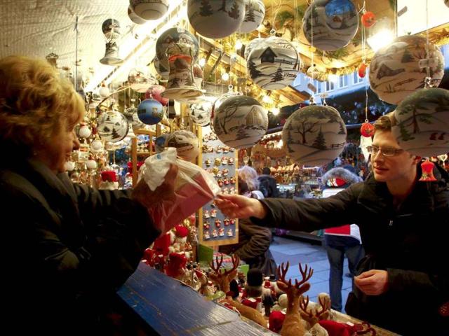 An unidentified man buys Christmas tree decorations at Munich's Christmas market. Reuters/Michaela Rehle