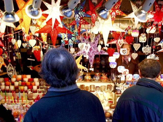 People visit a shop selling illuminated window stars in different colours at Munich's Christmas market. Reuters/Michaela Rehle