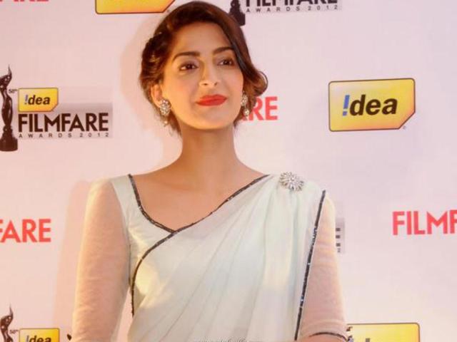 Sonam looked stylish and elegant in a simple white sheen sari with classy earrings and a matching brooch to go with it. Sonam looked stylish and elegant in a simple white sheen sari with classy earrings and a matching brooch to go with it.