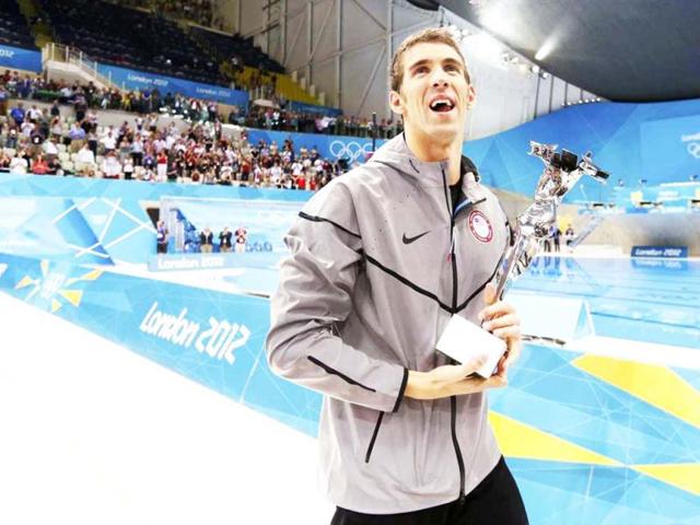 Michael Phelps of the US holds his trophy awarded to him by FINA honouring him as the most decorated Olympian of all time, after winning the men's 4x100m medley relay final during the London 2012 Olympic Games at the Aquatics Centre. Reuters Photo