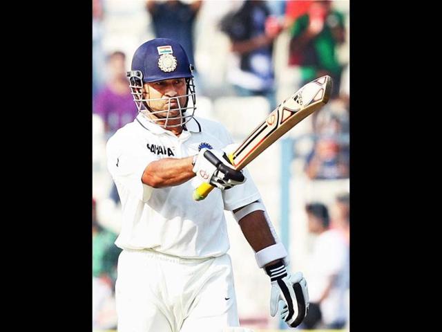 Sachin Tendulkar celebrates his half century on Day 1 of the 3rd India-England cricket test match at Eden Garden in Kolkata on Wednesday. He announced his retirement from ODI on Sunday. PTI Photo