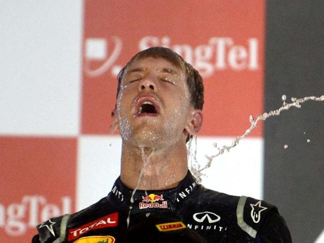 Sebastian Vettel made history as the youngest ever triple-world champion after a sixth place finish in a wild season-ending Brazilian Grand Prix 2012. AFP Photo
