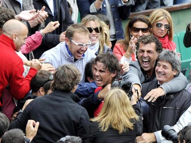 Rafael Nadal celebrates with his sister his staff members and his family after winning against Serbia's Novak Djokovic their Men's Singles final tennis match of the French Open tennis tournament at the Roland Garros stadium, on June 11, 2012 in Paris. AFP Photo