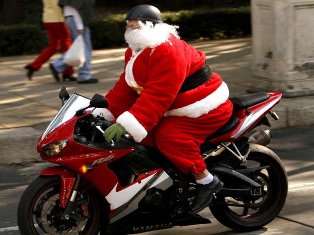 A man disguised as Santa Claus rides a motorcycle in Mexico City. (AP Photo)