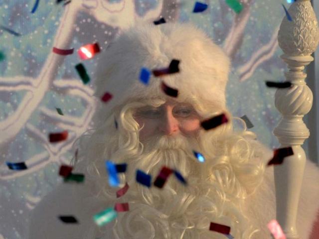 An actor dressed as Ded Moroz (Grandfather Frost), the Russian Santa Claus, smiles through smoke from a fire cracker and flying confetti during a welcome ceremony for him in Moscow's Gorky Park. (AFP Photo)