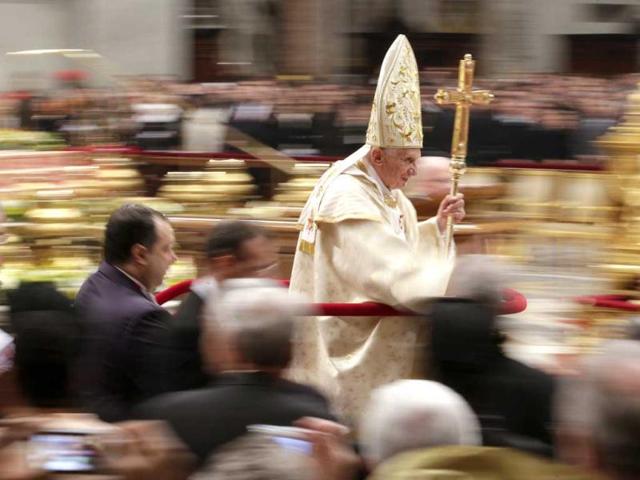Pope Benedict XVI leaves at the end of the Christmas night mass in the Saint Peter's Basilica at the Vatican. (Reuters)