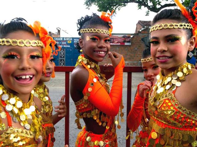 Young dancers smile as they prepare for the Salsodromo parade, which marks the start of the 55th Fair of Cali in Cali, Colombia. AFP Photo