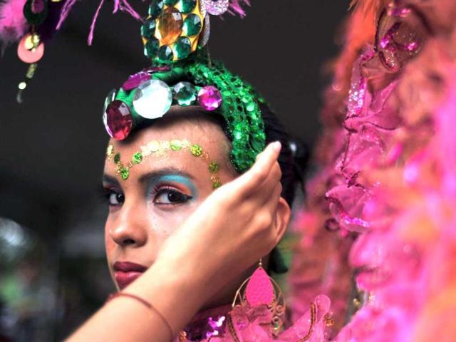 A young dancer prepares for the Salsodromo parade, which marks the start of the 55th Fair of Cali in Cali, Colombia. AFP Photo
