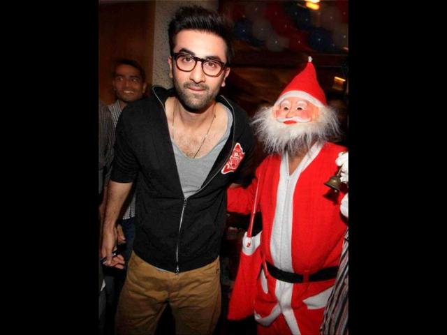 Ranbir Kapoor poses with a child dressed as Santa Claus as he celebrates Christmas with cancer affected children in Mumbai. PTI Photo