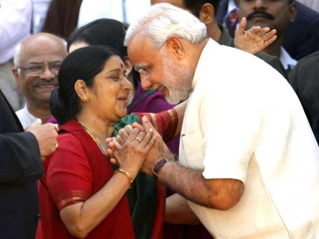 Gujarat Chief Minister Narendra Modi exchanges greetings with senior BJP leader Sushma Swaraj during his oath-taking ceremony at Sardar Patel Stadium in Ahmedabad. A galaxy of top BJP leaders and those of its allies were present during the swearing-in ceremony. (PTI Photo)