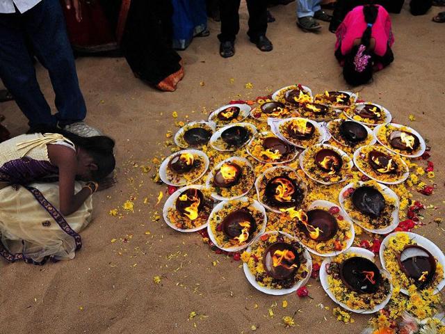 A girl offers prayers for the victims of the 2004 tsunami at Marina Beach in Chennai. PTI/R Senthil Kumar