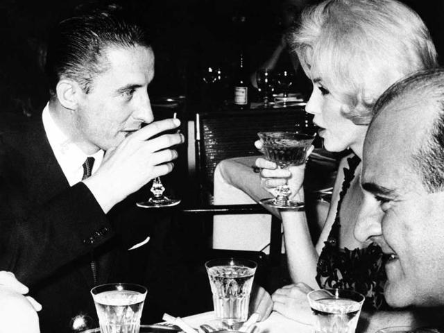 In this 1962 file photo, Marilyn Monroe and Jean Pierre Piquet, left, manager of Continental Hilton Hotel, are seen lifting their champagne glasses at a reception offered to the visiting star, in Mexico City. In late 2012, the FBI has released a new version of files it kept on Monroe that reveal the names of some of her acquaintances who had drawn concern from government officials and members of her entourage over their suspected ties to communism. (AP Photo)