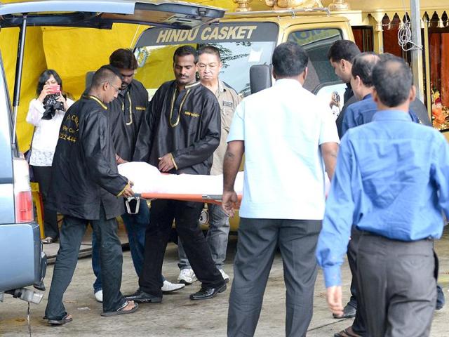 The body of the dead gangrape victim arrives at a funeral parlour for embalment in Singapore. AFP