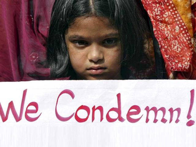 A girl holds a placard as she takes part in a protest rally in Hyderabad. Reuters Photo