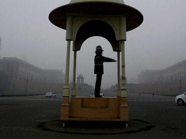 A traffic policeman discharges his duty at Vijay Chowk during a cold and foggy morning in New Delhi on the first day of the New Year. PTI/Atul Yadav