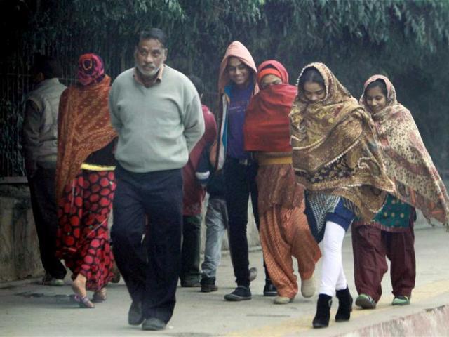 A group of morning-walkers wrapped in warm clothes during a cold day in New Delhi on the first day of the New Year. PTI/Atul Yadav