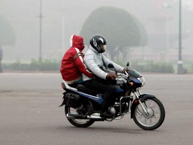 A couple riding a motorcycle during a cold and foggy morning in New Delhi on the first day of the New Year. PTI/Atul Yadav
