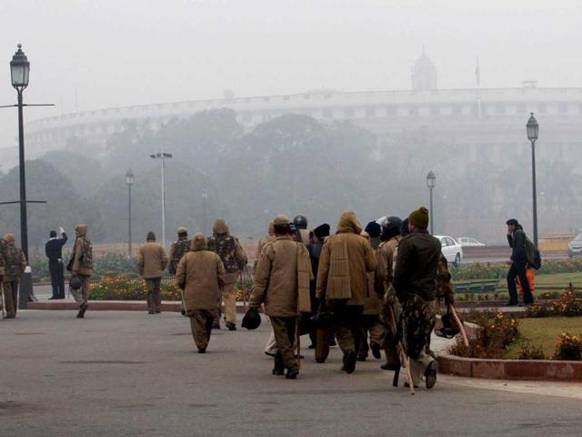 Security personnel moving along a road near parliament during a cold and foggy morning in New Delhi on the first day of the New Year. PTI/Kamal Singh