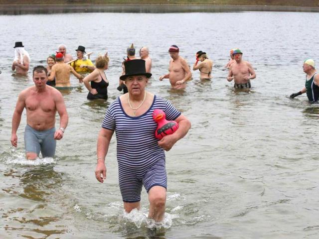 Members of the Berliner Seehunde (Berlin Seals) ice swimmers club take a dip in Lake Orankesee during their traditional New Year swimming event in Berlin. Reuters