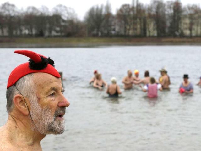 Members of the Berliner Seehunde (Berlin Seals) ice swimmers club take a dip in Lake Orankesee during their traditional New Year swimming event in Berlin. Reuters