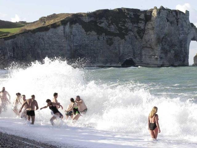 People participate in a traditional New Year's Day swim in front of the famous cliff at Etretat, western France. Reuters