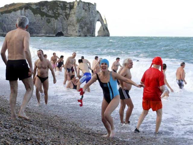 People participate in a traditional New Year's Day swim in front of the famous cliff at Etretat, western France. Reuters