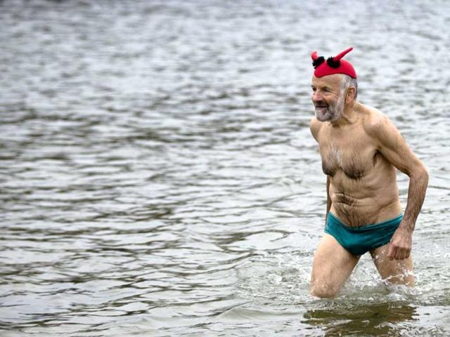 A man with a fancy cap leaves the water after he attended the annual New Year's swimming at Oranke Lake in Berlin. AP Photo