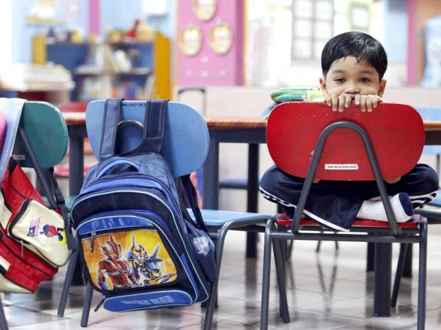 Preschooler Amni Roslan, 6, stays in class as he refuses to join his classmates for outdoor activities during his first day of school in Putrajaya, outside Kuala Lumpur. Reuters Photo