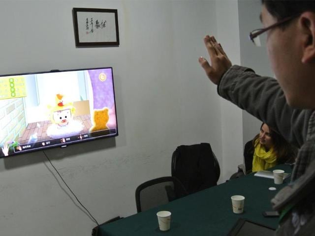 A-developer-tests-a-game-for-children-in-an-office-in-Chengdu-southwest-China-s-Sichuan-province-on-December-12-2012-Photo-AFP-Sebastien-Blanc A-developer-tests-a-game-for-children-in-an-office-in-Chengdu-southwest-China-s-Sichuan-province-on-December-12-2012-Photo-AFP-Sebastien-Blanc