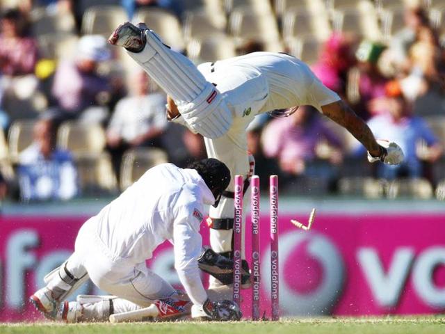 Australia's Mitchell Johnson (top) collides with Sri Lanka's wicket keeper Dinesh Chandimal on the second day of their cricket test match in Sydney, Australia. Sri Lanka made 294 all out in their first innings. AP Photo