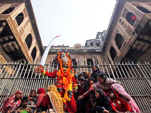A man, dressed as a Sadhu, joins others as they watch a religious procession by Naga Sadhus towards the Sangam ahead of Maha Kumbh Mela that begins at Allahabad Jan 14. (AP Photo)