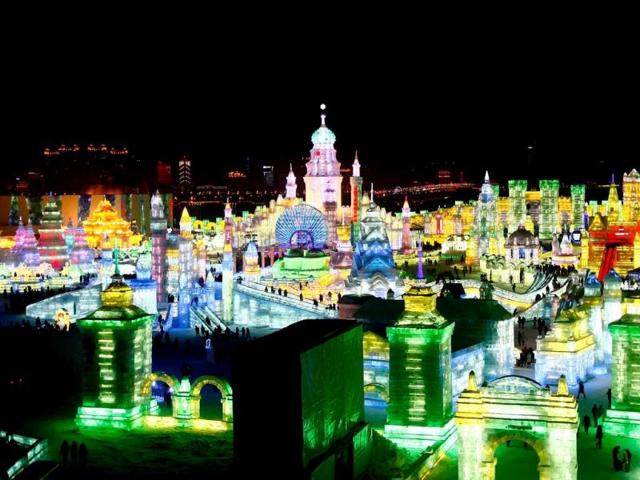 Visitors view ice sculptures during the official opening of the 29th Harbin International Ice and Snow Festival in Harbin in northeast China's Heilongjiang province. This year's "Ice and Snow World" features majestic ice castles and sculptures of fairytale characters. (AP Photo)