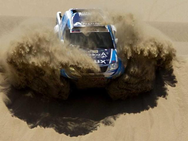Totoya's Lucio Alvarez and co-driver Bernardo Graue of Argentina compete in the 1st stage of the 2013 Dakar Rally between Lima Pisco, Peru. (AP Photo)