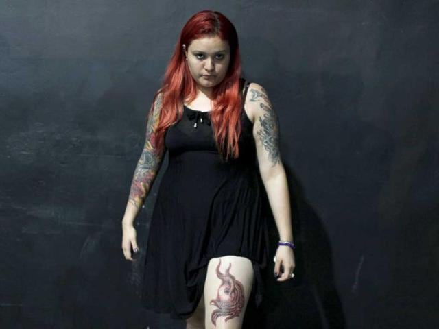 A woman poses for a photo to show off her tattoos at the International Tattoo and Body Piercing Convention in Rio de Janeiro. (Reuters)
