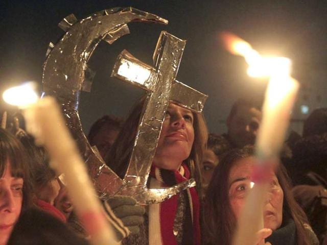 Egyptian Muslims and Christians celebrate Coptic Christmas eve mass, at Tahrir Square in Cairo. (Reuters)