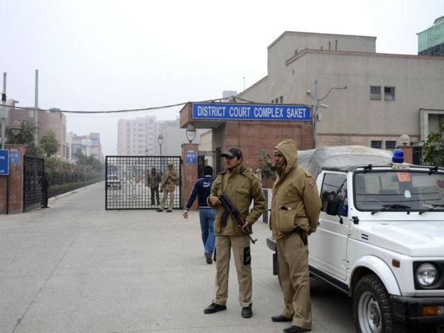 Indian police personnel stand guard at an entrance to Saket district court in New Delhi after the accused in the Delhi gangrape and murder case were produced before court. (AFP Photo)