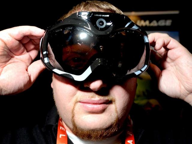 John Noonan displays a pair of Liquid Image goggles with a built in camera at the 2013 International CES in Las Vegas. The goggles which have built-in WiFi are currently available in the market and have a retail price of $ 399. (AFP Photo)