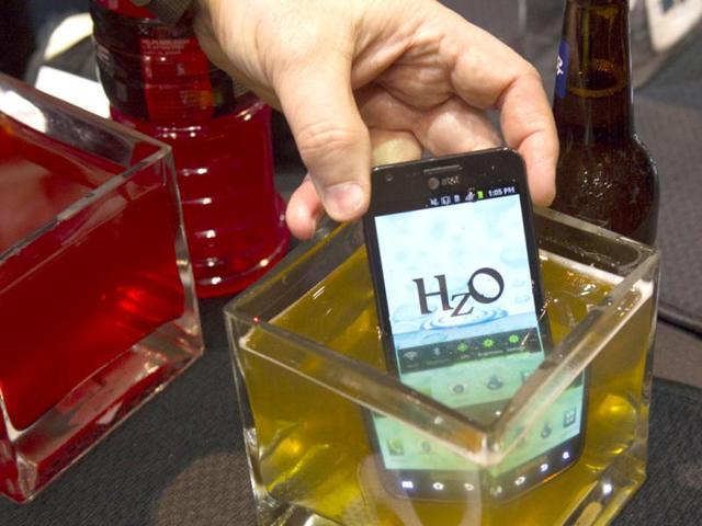 A smartphone with HzO Waterblock technology is dipped in beer at the Consumer Electronics Show (CES) in Las Vegas. The system is currently marketed at manufacturers but may have future consumer applications. (Reuters)