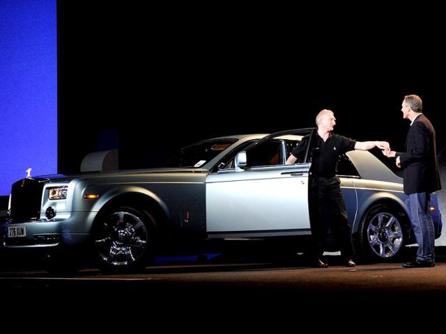 Qualcomm Inc., Chairman and CEO Dr. Paul E. Jacobs (R) receives the keys to an all electric Rolls Royce during a keynote address at the 2013 International CES at The Venetian in Las Vegas, Nevada. AFP photo