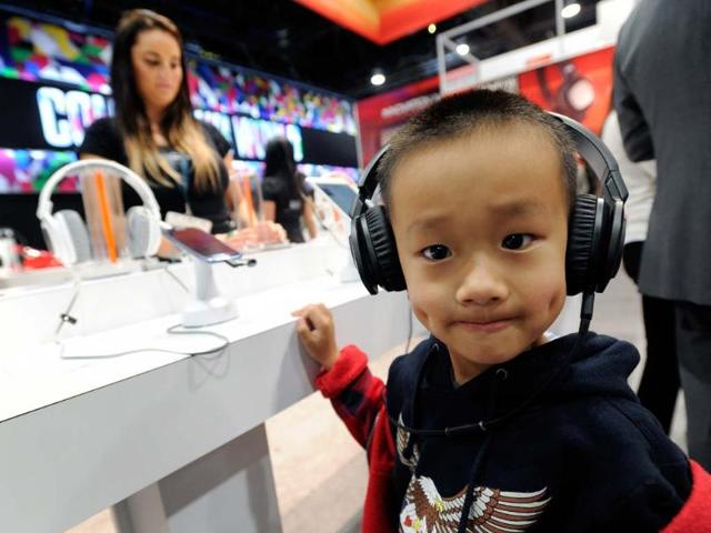 A-young-attendee-listens-to-music-on-a-pair-of-JBL-J88i-headphones-at-the-Harman-Kardon-booth-at-the-2013-International-CES-at-the-Las-Vegas-Convention-Center-on-January-9-2013-in-Las-Vegas-Nevada-CES-the-world-s-largest-annual-consumer-technology-trade-show-runs-through-January-11-and-is-expected-to-feature-3-100-exhibitors-showing-off-their-latest-products-and-services-to-about-150-000-attendees-Photo-David-Becker-Getty-Images-AFP A-young-attendee-listens-to-music-on-a-pair-of-JBL-J88i-headphones-at-the-Harman-Kardon-booth-at-the-2013-International-CES-at-the-Las-Vegas-Convention-Center-on-January-9-2013-in-Las-Vegas-Nevada-CES-the-world-s-largest-annual-consumer-technology-trade-show-runs-through-January-11-and-is-expected-to-feature-3-100-exhibitors-showing-off-their-latest-products-and-services-to-about-150-000-attendees-Photo-David-Becker-Getty-Images-AFP