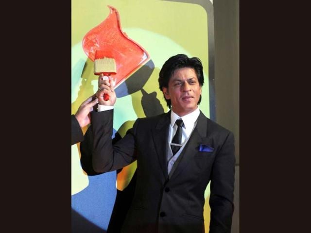 Bollywood Actor Shah Rukh Khan paints the wall as he attends a Nerolac paints promotional event in Mumbai on January 11.