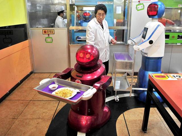 A robot delivers French fries to customers at a Robot Restaurant in Harbin. Reuters Photo