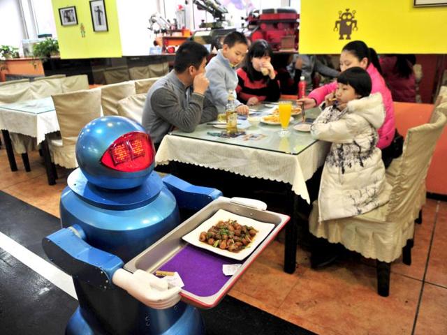 A robot delivers a dish to customers at a Robot Restaurant in Harbin. Reuters Photo
