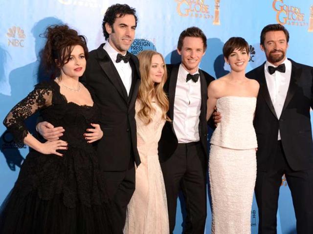 From L to R, actors Helena Bonham Carter, Sacha Baron Cohen, Amanda Seyfried, Eddie Redmayne, Anne Hathaway and Hugh Jackman pose with the best motion picture comedy or musical award for Les Miserables at the Golden Globes awards ceremony in Beverly Hills. (AFP PHOTO)
