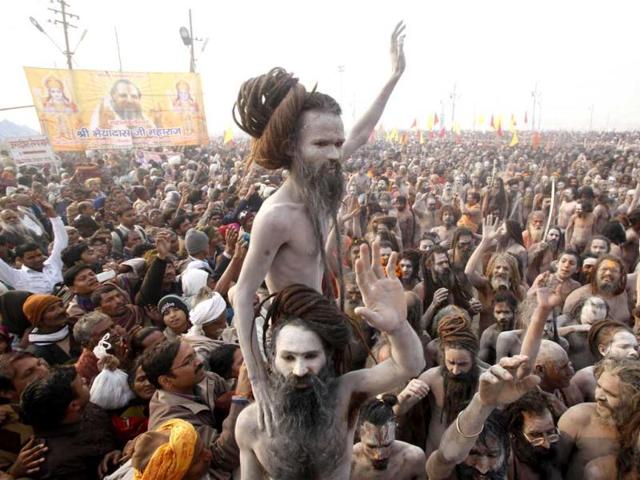 Naga sadhus return to their camp after a dip at Sangam, the confluence of the rivers Ganges, Yamuna and mythical Saraswati on one of the most auspicious days in Allahabad. AP/Rajesh Kumar Singh