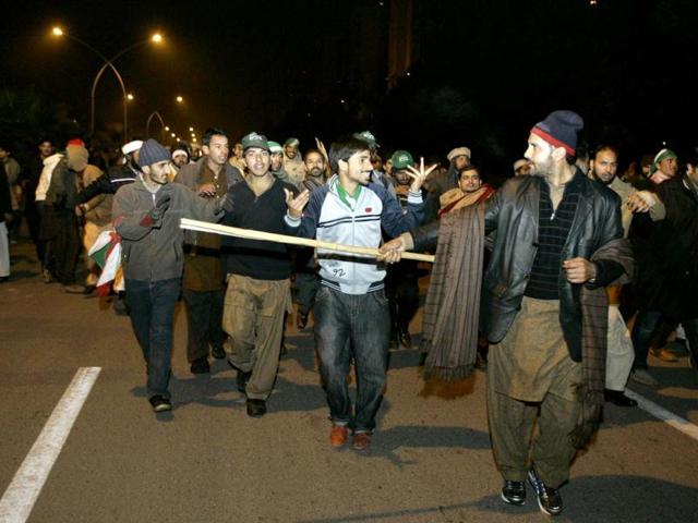 Supporters of Pakistani Sunni Muslim cleric Tahir-ul-Qadri, march towards high security area Red Zone at an anti-government rally in Islamabad, Pakistan. AP Photo