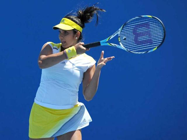 Sania Mirza plays a return during her women's doubles match with Bethanie Mattek-Sands of the US against Spain's Silvia Soler-Espinosa and Carla Suarez-Navarro on the third day of the Australian Open tennis tournament in Melbourne. AFP